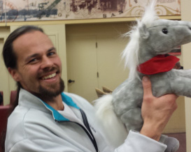 Buttner shows off the stuffed pony that Wells Fargo gave him for opening a new direct deposit account