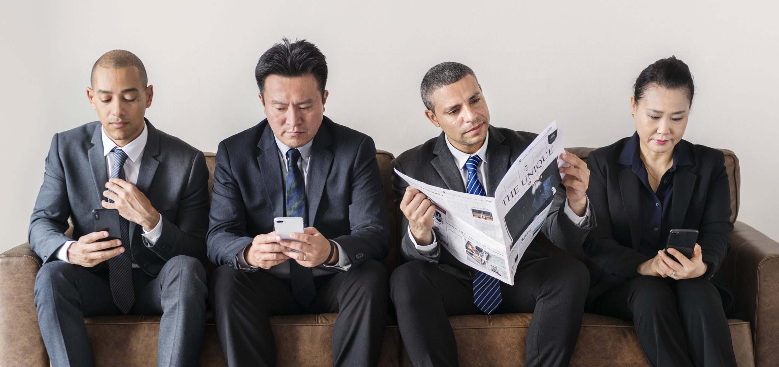 Business people busy with mobile and reading newspaper Business people busy with mobile and reading newspaper