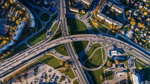 Aerial view of cars driving on freeways that go to four different directions