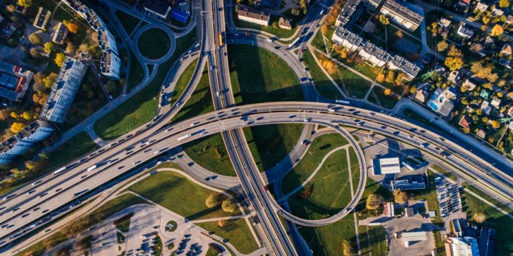 Aerial view of cars driving on freeways that go to four different directions