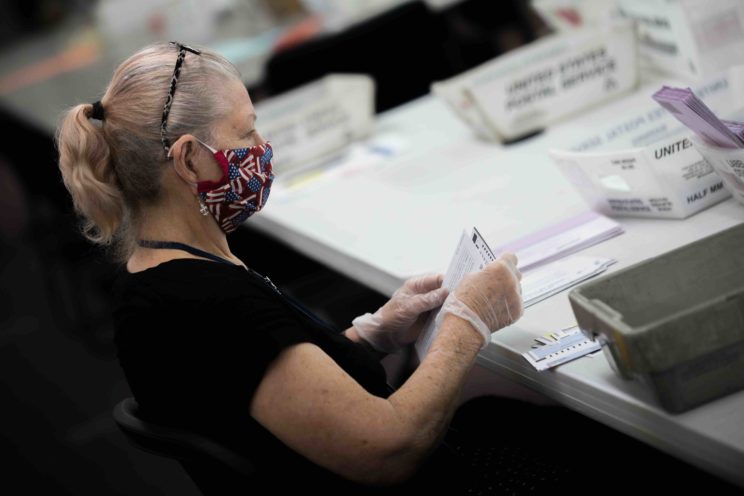Election poll workers wear masks during the 2020 primary election day in Nevada.