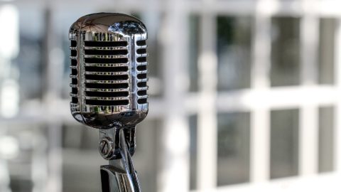 Microphone in the office with a building background on the back.