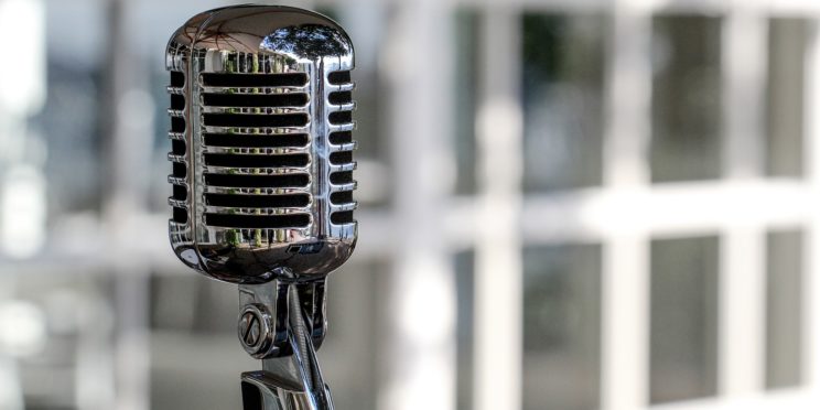 Microphone in the office with a building background on the back.