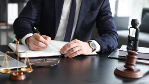 Male lawyer sitting at workplace in office