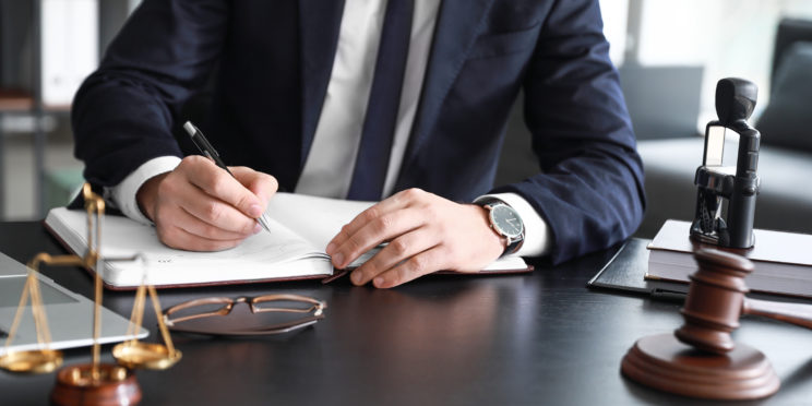 Male lawyer sitting at workplace in office