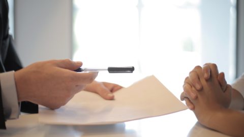 man asking woman to sign a document