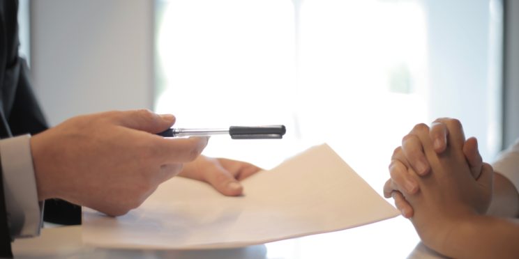 man asking woman to sign a document