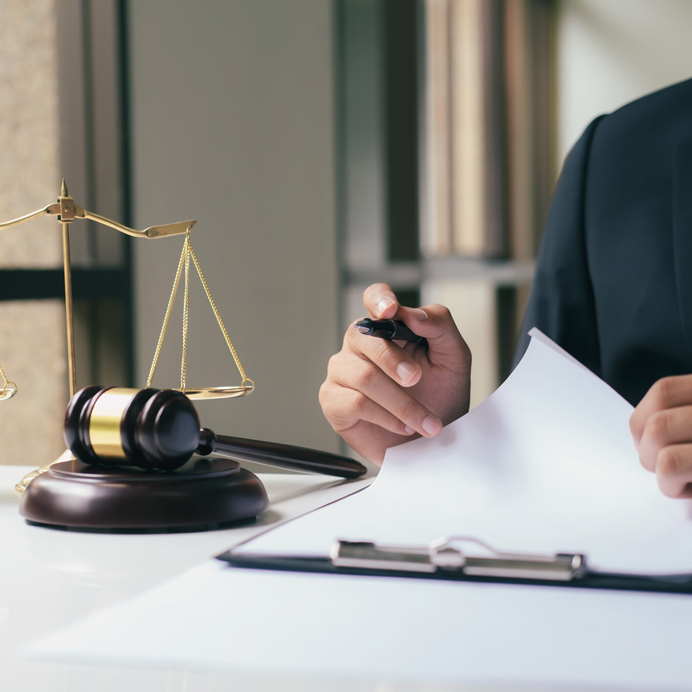 Justice and law concept.Male lawyer in the office with brass scale.